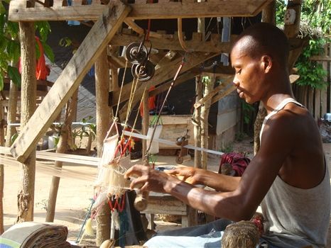 The history of Kente and Adinkra symbols<br>Kente weaver in action